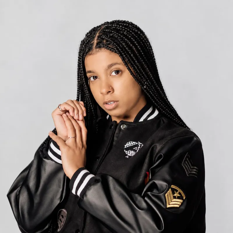 All-black leather-sleeve varsity jacket with patches
