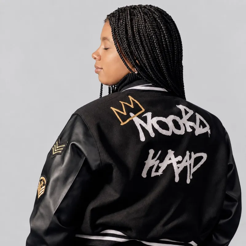 All-black varsity jacket with the NOORD KAAP crown print